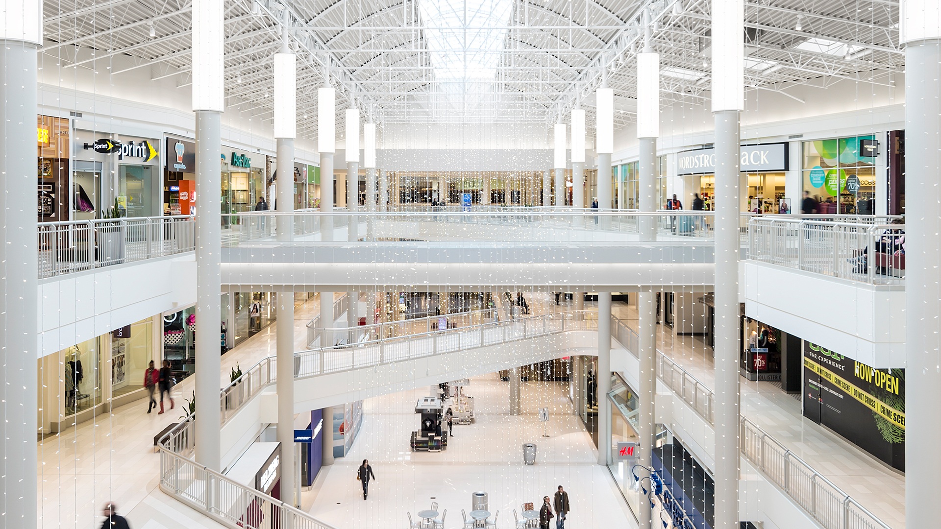 Photograph of the atrium in the northern section of the Mall of America. Three stories are bathed in natural sunlight. Everything is also… extremely white.